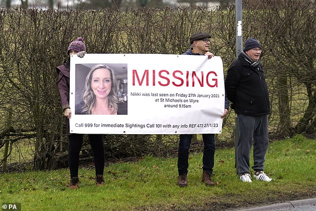 Members of the public line the road into St Michael's on Wyre, Lancashire, with missing posters of Ms Bulley