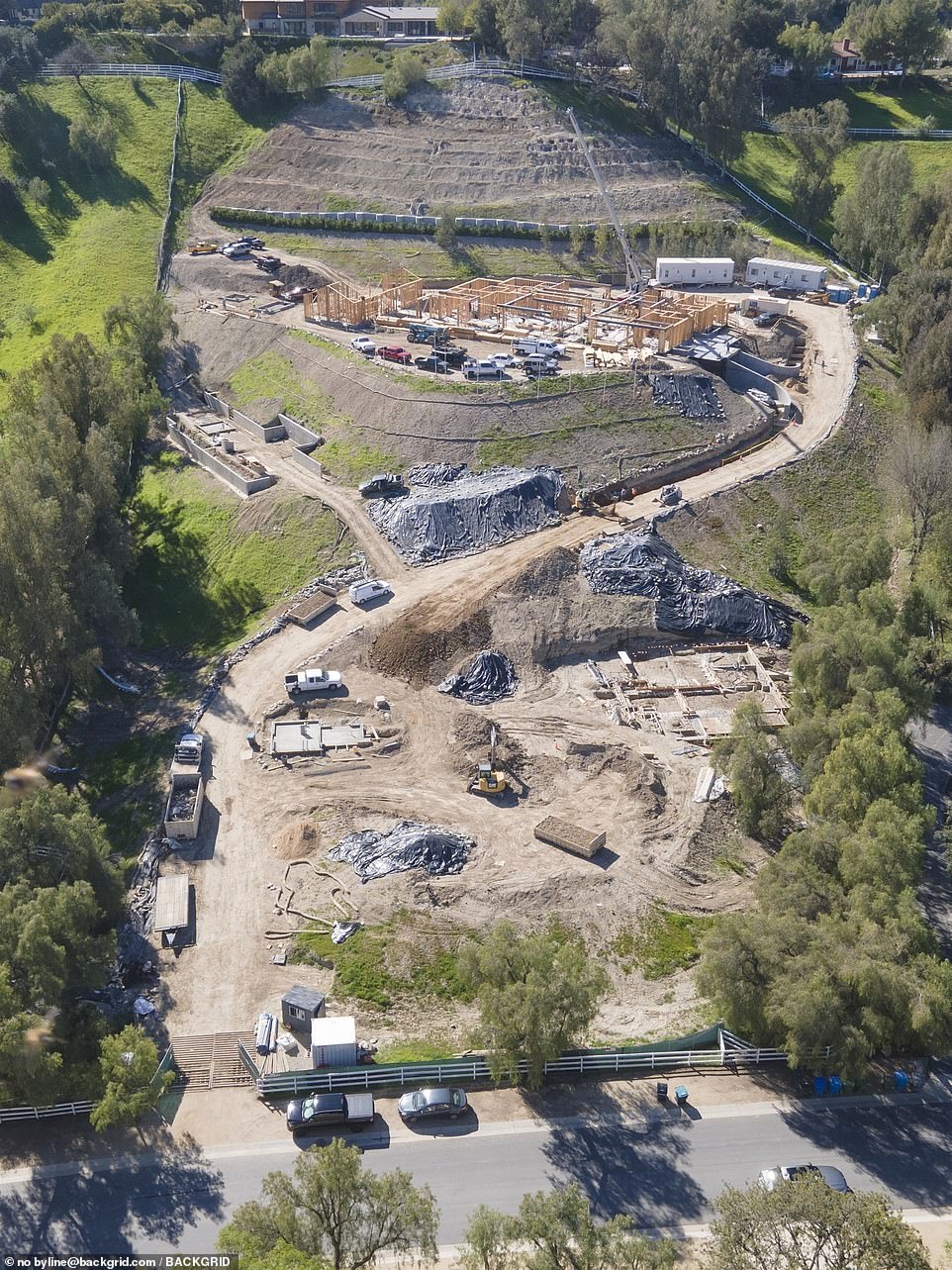 Starting to take shape: The wooden structure of the mansion had advanced considerably since it was seen last month, and a crane and multiple work trucks surrounded it. It had an underground entrance which may lead to her 12-car garage