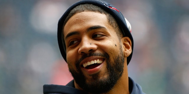 Injured Texans running back Arian Foster waits on the field before the game against the New England Patriots at Reliant Stadium on Dec. 1, 2013, in Houston.