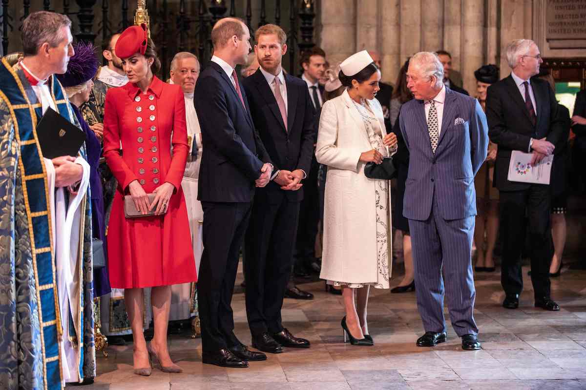 Prince Harry, whom a commentator says the royal family doesn't want a coronation reconciliation with, stands with Kate Middleton, Prince William, Meghan Markle, and King Charles III