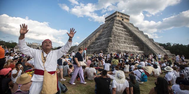 People surround the Kukulcan Pyramid at the Mayan archaeological site of Chichen Itza in Yucatan State, Mexico, during the celebration of the spring equinox on March 21, 2022. 