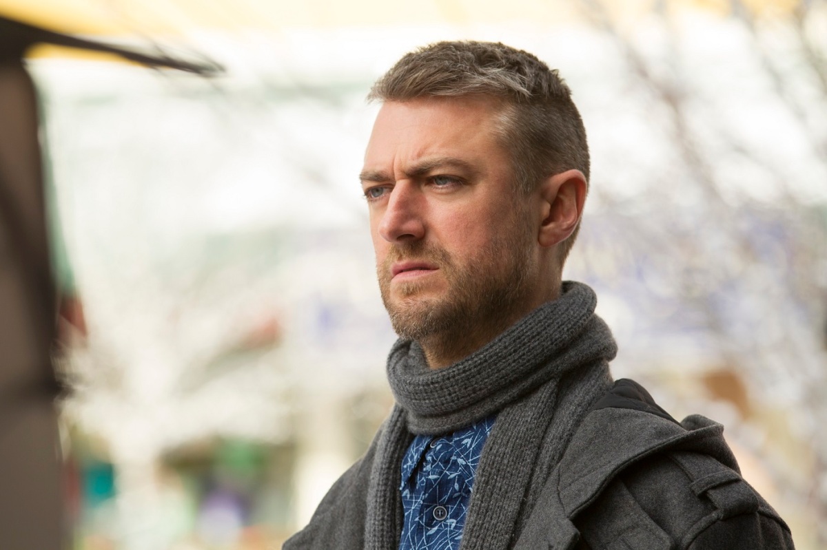 Sean Gunn as Kirk Gleason stands in a coat during 'Gilmore Girls: A Year in the Life'