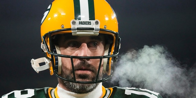 Green Bay Packers quarterback Aaron Rodgers (12) breaths out as he warms up before an NFL football game against the Los Angeles Rams in Green Bay, Wis. Monday, Dec. 19, 2022.
