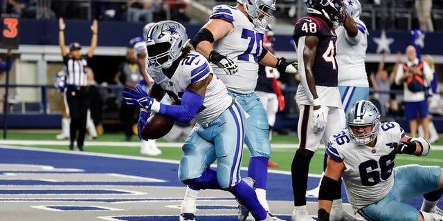 Dallas Cowboys running back Ezekiel Elliott (21) scores a touchdown during the second half of a game against the Houston Texans Dec. 11, 2022, in Arlington, Texas. 