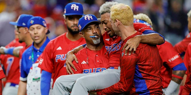 Puerto Rico pitcher Edwin Diaz is carried off the field after an apparent leg injury during the team celebration against Dominican Republic at LoanDepot Park.