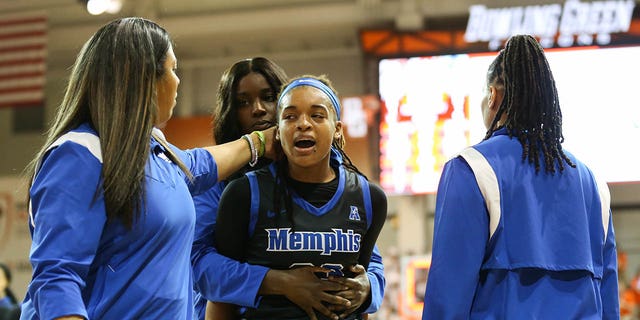 Memphis Tigers guard Jamirah Shutes, center, is escorted off the court after an altercation with Bowling Green Falcons guard Elissa Brett at the Stroh Center in Bowling Green, Ohio, on Thursday.
