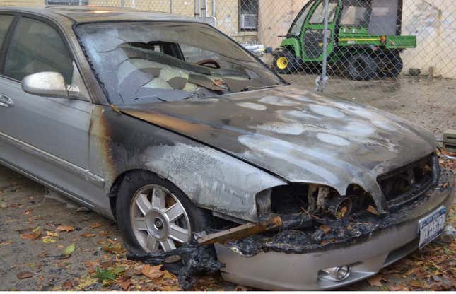 A car caught fire outside of the old Coney Island Hospital during Hurricane Sandy in 2012. 