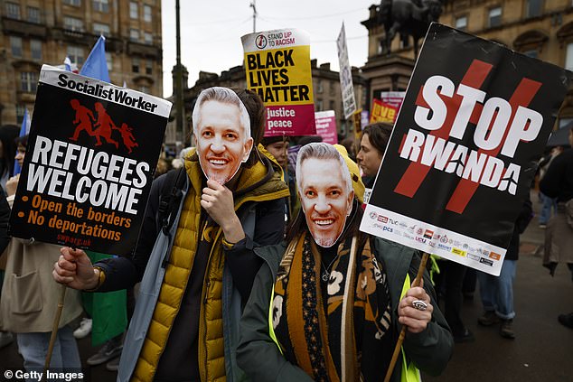 People wearing Gary Lineker masks march during a Stand Up To Racism protest today at George Square in Glasgow