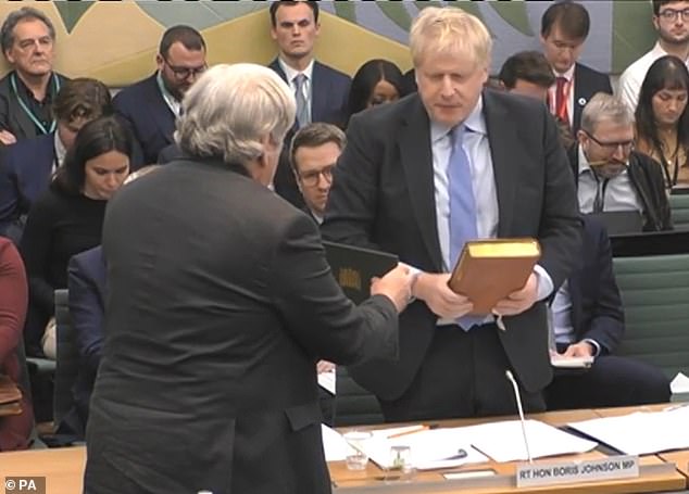 After taking an oath on the bible, Mr Johnson made an opening statement saying he acknowledged 'public anger' and apologised for 'what happened on my watch'