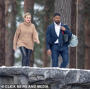 Shooting: The pair were seen walking across the snow-covered landscape before stopping to overlook a rock face
