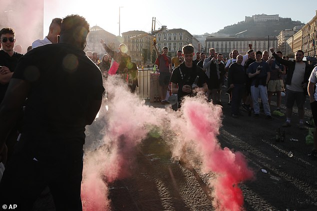 England fans cheer as flares are set off before kick-off at the Stadio Diego Armando Maradona in Naples tonight