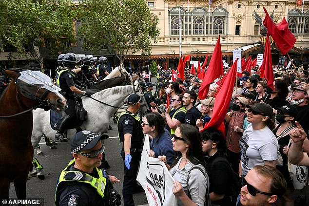 Transgender rights supporters are held back by police during a rally invaded by Neo-Nazis