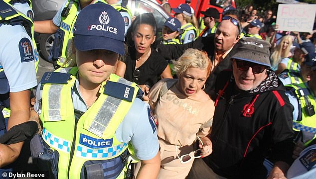 Controversial anti-trans activist Kellie-Jay Keen was doused with tomato juice at her Auckland rally on Saturday, forcing her to leave the protest early in the back of a police car and question whether to go forward with her upcoming rally in Wellington