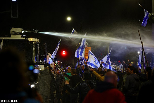 A police water cannon is used against protesters opposed to the judicial reforms in Jerusalem on Sunday