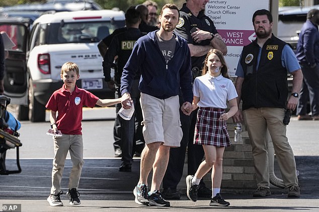 A man takes two children home from The Covenant School after Monday's shooting