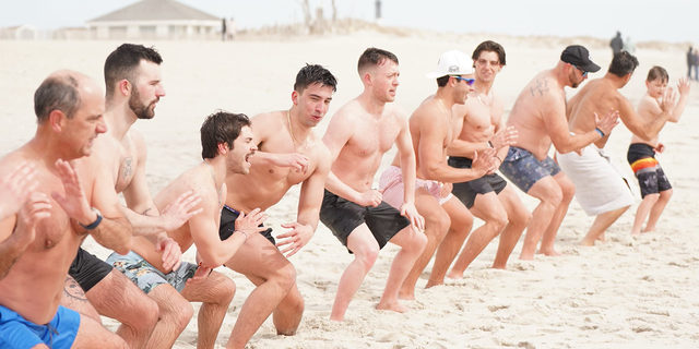 Cold plunge group "Sunday Swim" practices Wim Hof's horse stance to induce blood flow while gathered on Robert Moses beach on Long Island, New York, March 12, 2023.