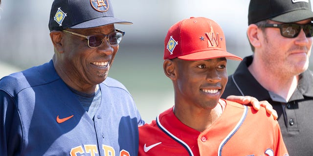 Houston Astros manager Dusty Baker poses with his son, Washington Nationals minor league player Darren Baker, after exchanging lineups before a spring training game at The Ballpark of The Palm Beaches March 19, 2022, in West Palm Beach, Fla. 