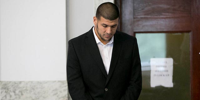 Aaron Hernandez stood in the court room. Former New England Patriots tight end Aaron Hernandez appeared in Attleboro District Court in Attleboro, Mass. on Wednesday, July 24, 2013. 