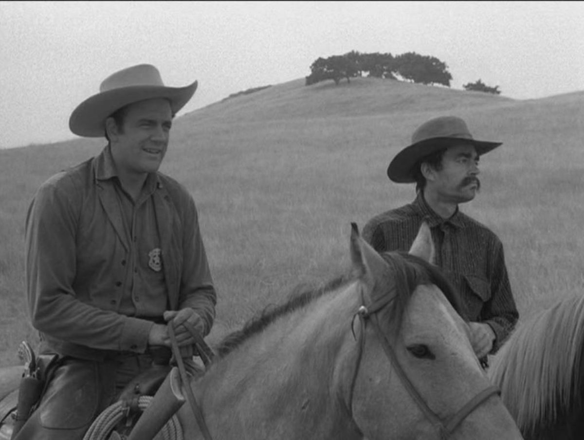 'Gunsmoke' 'Jayhawkers' James Arness as Matt Dillon and Jack Elam as Dolph Quince on horseback in a field.