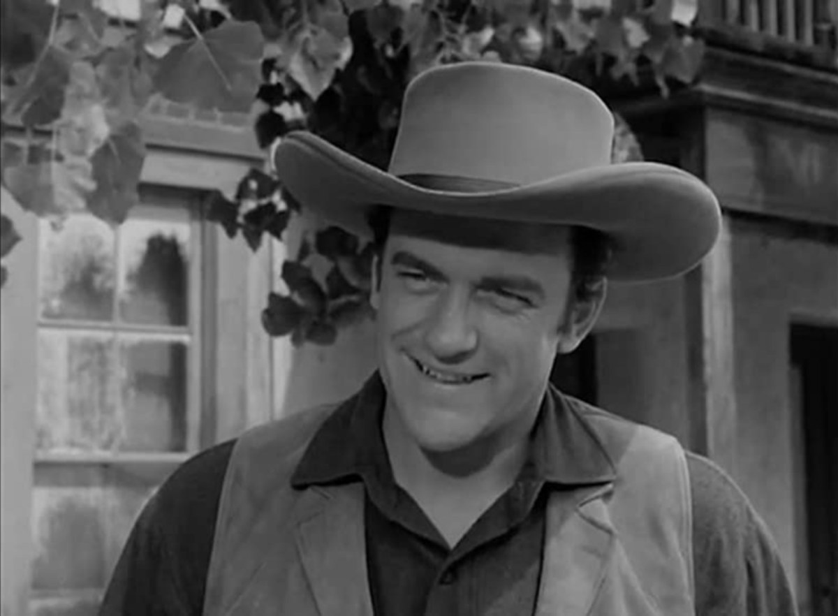 'Gunsmoke' 'Lost Rifle' James Arness as Matt Dillon smiling, wearing a marshal costume in front of a window.
