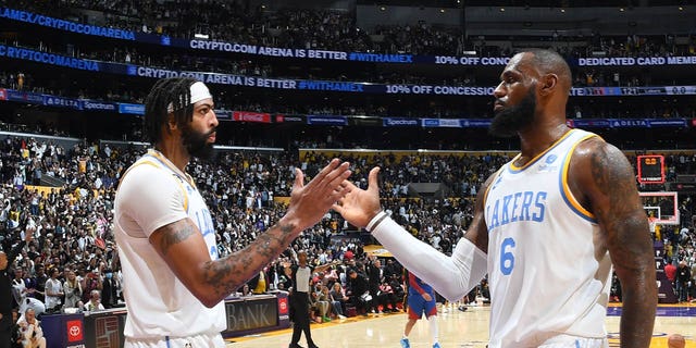 LeBron James (6) and Anthony Davis (3) of the Los Angeles Lakers high-five after a game against the Denver Nuggets Oct. 30, 2022, at Crypto.Com Arena in Los Angeles.