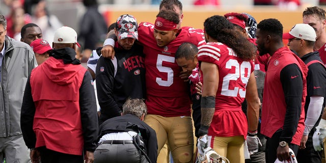 San Francisco 49ers quarterback Trey Lance (5) is helped onto a cart during the first half of an NFL football game against the Seattle Seahawks in Santa Clara, Calif., Sunday, Sept. 18, 2022.