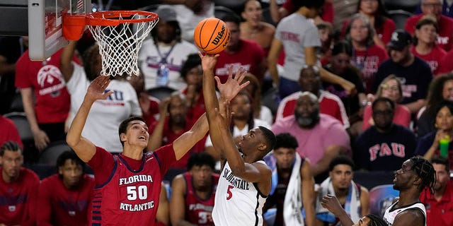 San Diego State guard Lamont Butler (5) shoots over Florida Atlantic center Vladislav Goldin (50) during the first half of a Final Four game in the NCAA Tournament Saturday, April 1, 2023, in Houston.