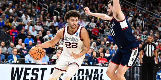 Anton Watson (22) of the Gonzaga Bulldogs handles the ball against Alex Karaban (11) of the Connecticut Huskies during the Elite Eight of the 2023 NCAA Tournament at T-Mobile Arena March 25, 2023, in Las Vegas.