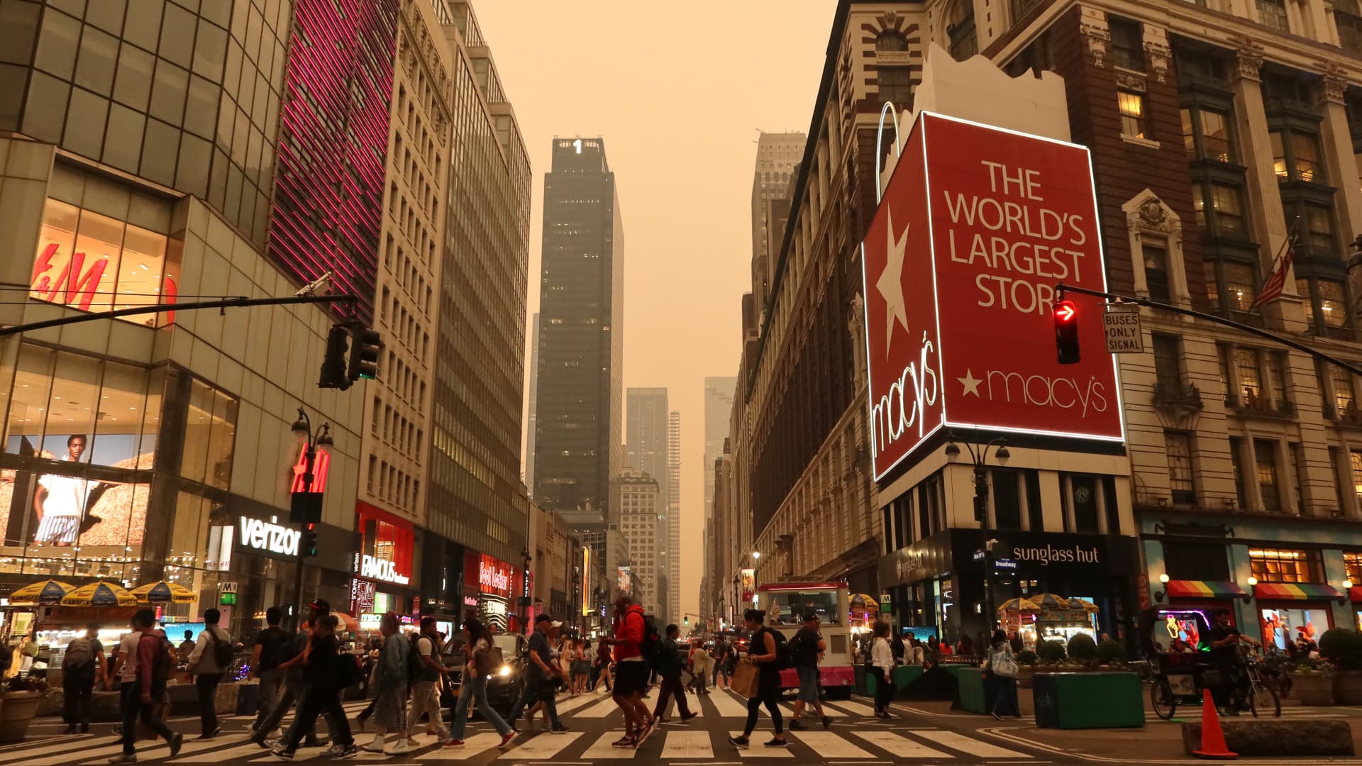 Heavy smoke fills the air as people cross 34th Street in Herald Square, Manhattan, New York, June 6, 2023.