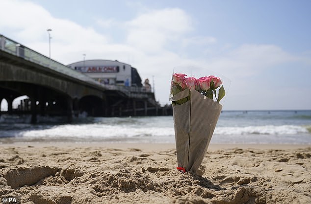 A bunch of flowers left on Bournemouth beach for a 17-year-old-boy and a girl aged 12 who died yesterday