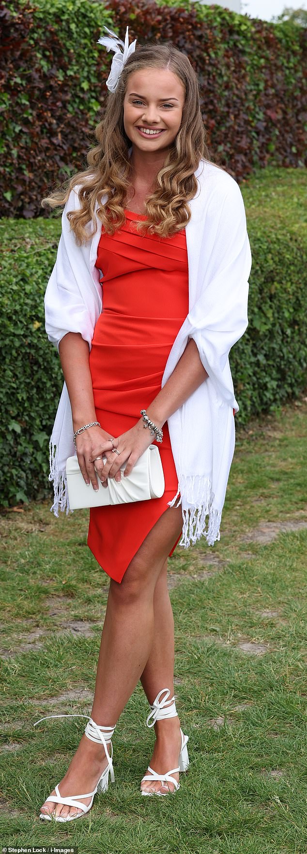 This glamorous racegoer opted for a red dress with a white shawl and white strappy sandals, with her hair in boho curls