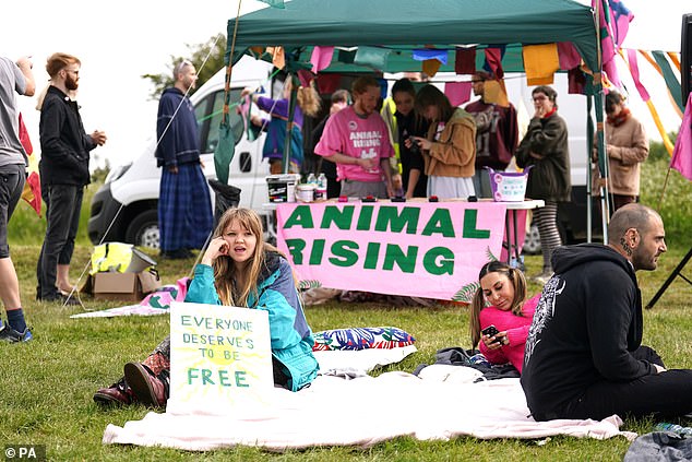 Activists gather ahead of the public arriving at Epsom racecourse later today