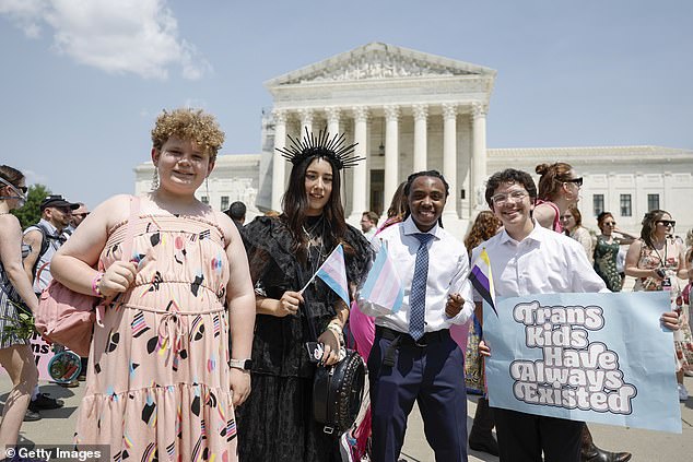 Grayson McFerrin, 12, Libby Gonzales, 13, Hobbes Chukumba, 16, and Daniel Trujillo, 15, the organizers of the "Trans Youth Prom" pose for a photo in front of the U.S. Supreme Court last month