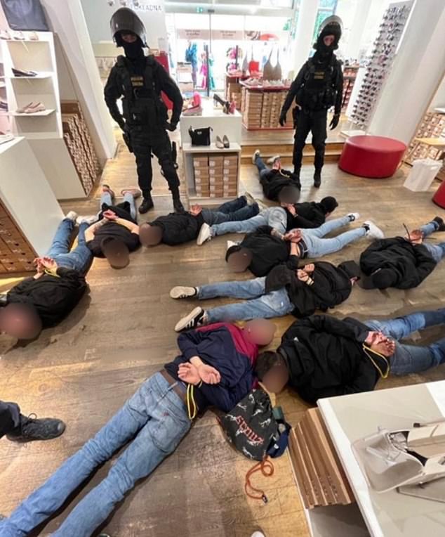 Pictured: A photograph released by Prague police shows a number of Fiorentina Ultras detained and lying prone on a shop floor in the Czech capital