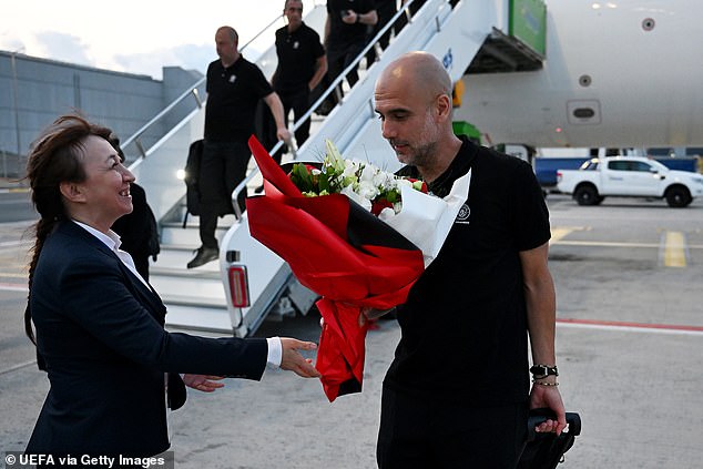 City manager Pep Guardiola (right) was handed a bouquet of flowers upon the arrival in Turkey