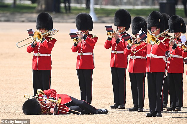 A member of The Band of the Welsh Guards appears to faint during today's ceremony