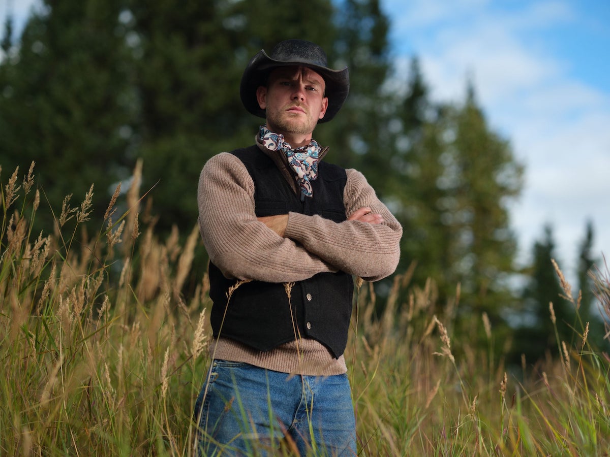 'Alone' Season 10 cast member Cade Cole with his arms crossed and wearing a cowboy hat
