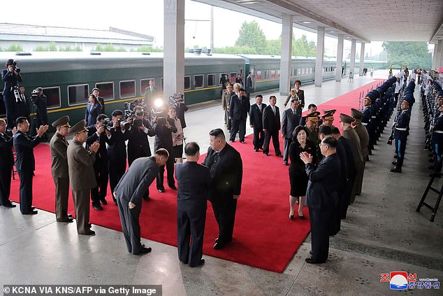 Pictured: North Korea's leader Kim Jong Un (C) receiving a red carpet send-off as he departs by train from Pyongyang for a visit to Russia on Sunday. He arrived in Russia on Tuesday