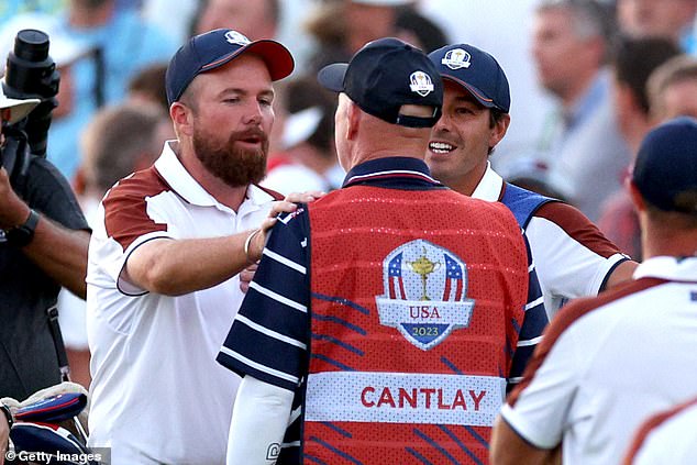 Shane Lowry could be seen exchanging word with the legendary caddie on the green
