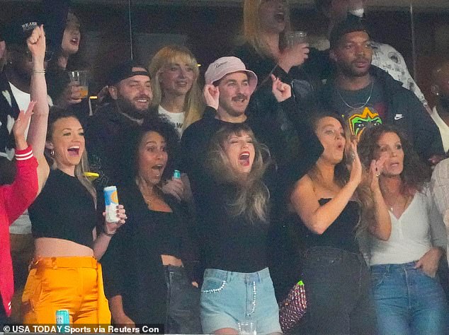 Taylor Swift raises her hands up during the game at MetLife Stadium while she watched Travis Kelche play