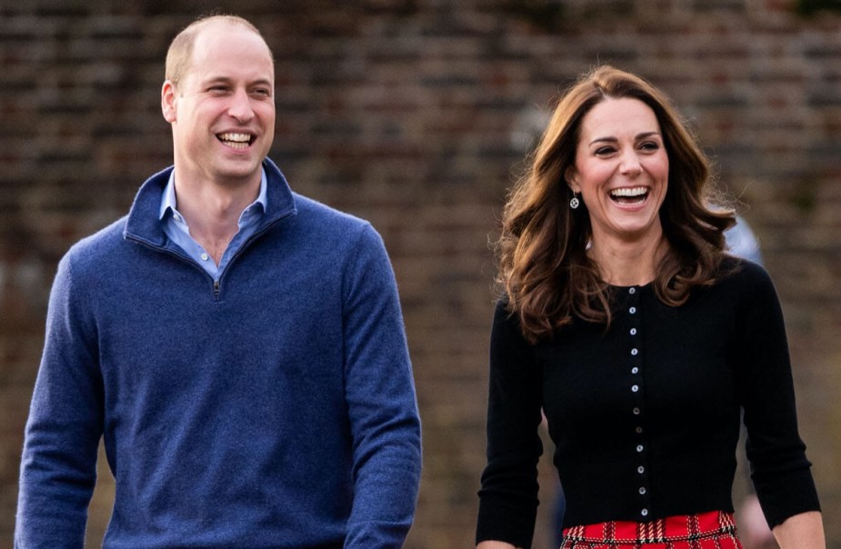 Prince William and Kate Middleton laughing together while walking