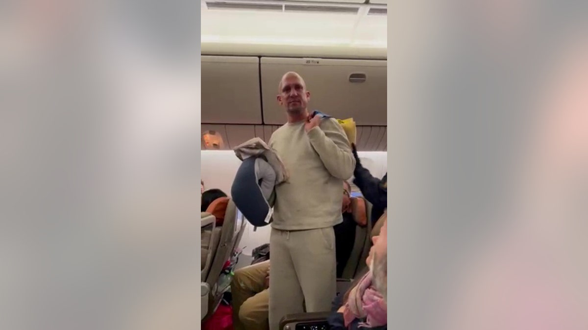 man on airplane was escorted off