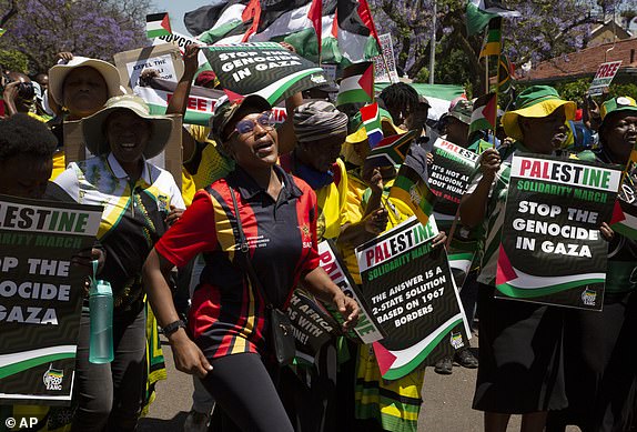 FILE - Pro-Palestinian supporters demonstrate at the entrance to the Israeli embassy in Pretoria, South Africa, Friday, Oct. 20, 2023. Israel has recalled its ambassador to South Africa, Eliav Belotserkovsky, back to Jerusalem "for consultations" ahead of a parliamentary vote in the African country to decide the fate of the Israeli embassy. The two countries' diplomatic relations have recently witnessed a rise in tensions over the Israeli war on Gaza which has killed thousands of people. (AP Photo/Denis Farrell, File)