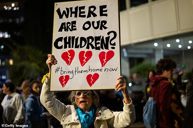 The parents and relatives of children kidnapped on October 7, along with families of hostages and their supporters take part in a demonstration outside the UNICEF headquarters in Tel Aviv yesterday