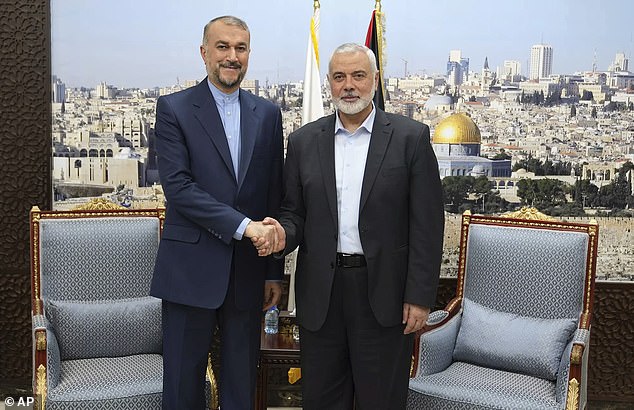 Hamas officials are 'close to reaching a truce agreement' with Israel and the group has delivered its response to Qatari mediators, Ismail Haniyeh (right) said in a statement. Pictured with Iran's Foreign Minister Hossein Amir-Abdollahian on 31 October