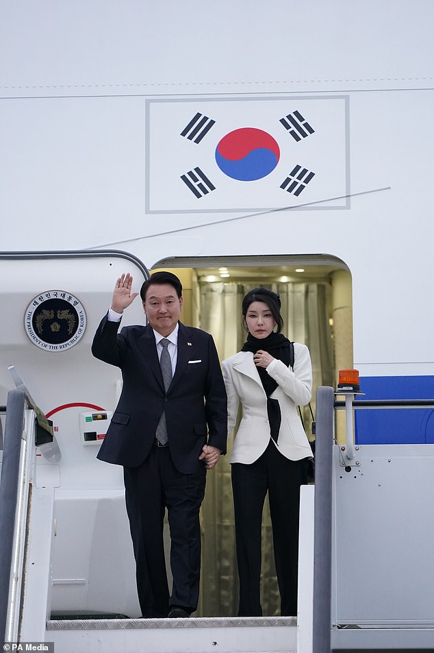 Mr Yoon and Mrs Kim arriving at Stansted Airport on Monday (PA)