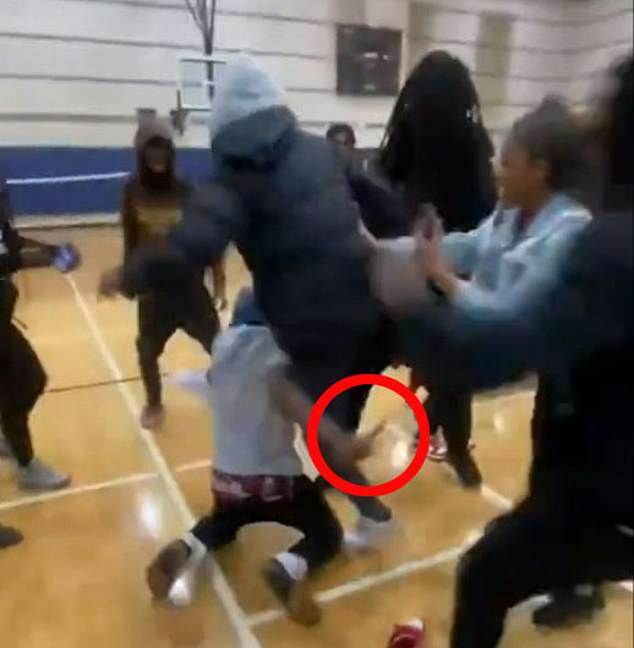 Students at a North Carolina high school are seen on Monday in a mass brawl in the gymnasium as a male in a grey hoodie is seen with a knife in hand. The teenage suspect is accused of stabbing Ferrell to death