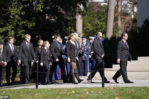 Carter family members walk as the casket of former first lady Rosalynn Carter arrives at Glenn Memorial Church at Emory University