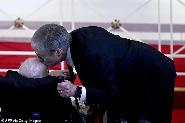 James "Chip" Carter kisses the head of his father, former US President Jimmy Carter, during a tribute service for Rosalynn Carter