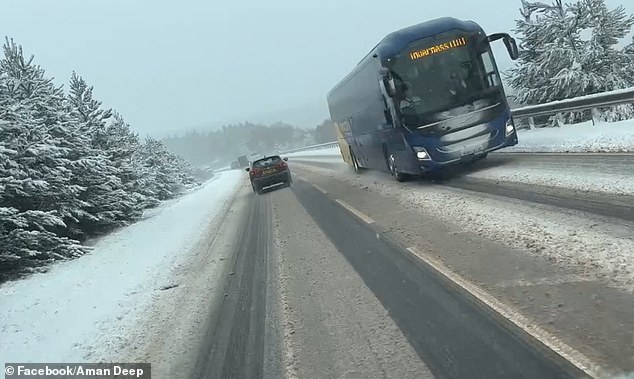 SCOTLAND: A bus travels along a snowy motorway as weather warnings are put in place
